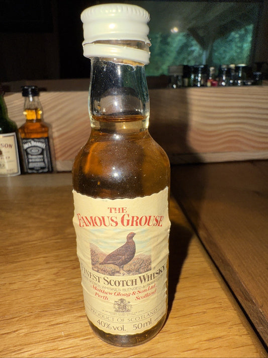The Famous Grouse Whisky Miniature top appears open but completely full