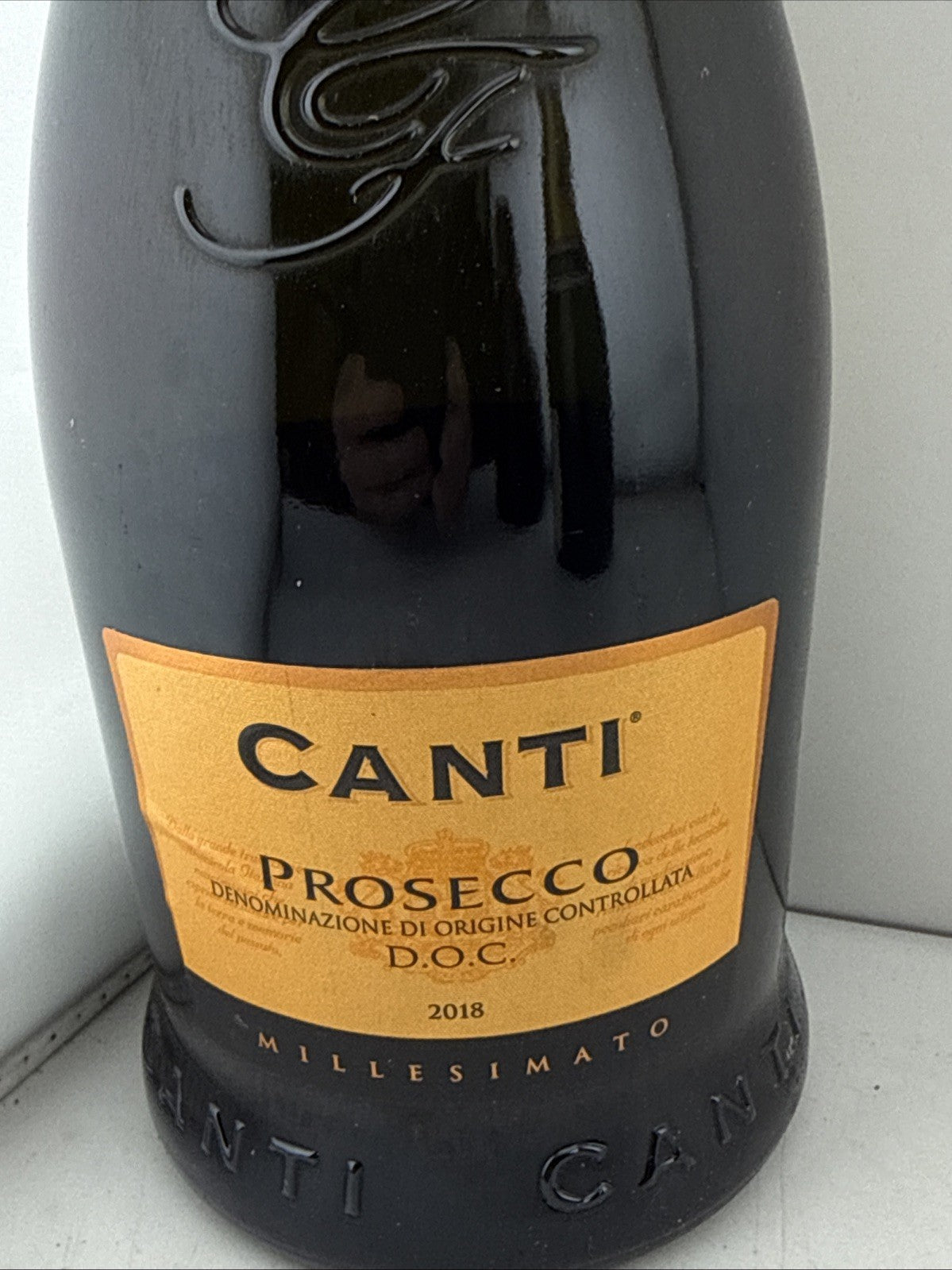 Sealed 2018 vintage Canti Prosecco DOC Millesimato in distinctive black bottle.
